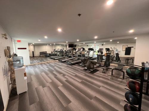 a gym with a bunch of treadmills and chairs at Staybridge Suites - Calgary Airport by IHG in Calgary