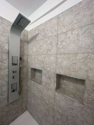 a bathroom with a stone wall with a fireplace at Maison Chic Montenero Marina in Marina di Montenero