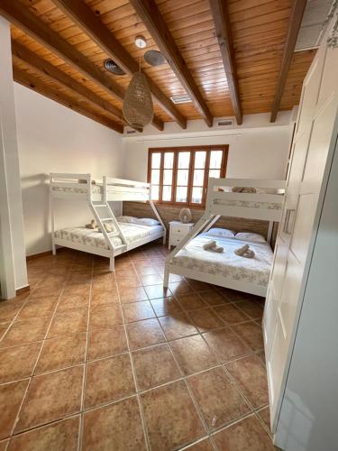 a room with two bunk beds and a tile floor at UIM Planta baja Canovas del Castillo, PLAYA WIFI in Puerto de Sagunto