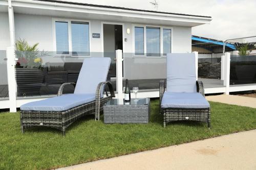 two chairs sitting on a lawn in front of a house at 406 Sea View Road in Bridlington