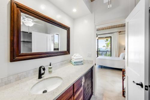 a bathroom with a sink and a mirror at Kona Bali Kai #368 in Kailua-Kona