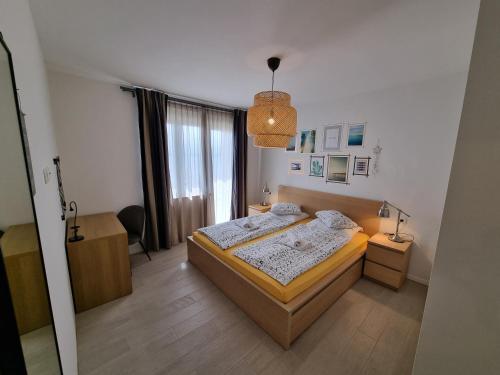 a bedroom with a bed and a desk and a window at Top view in Crikvenica