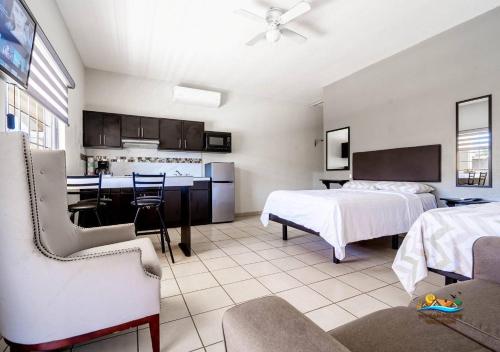 a hotel room with two beds and a kitchen at San Felipe rental - One block to San Felipe Malecon in San Felipe