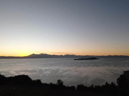 an island in a sea of clouds at sunset at Sol y Luna - ISLA DEL SOL in Comunidad Yumani