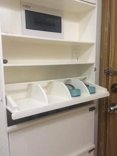 a kitchen counter with a microwave and some dishes at Roxas Blvd Stunning Studio Condo Near US Embassy in Manila