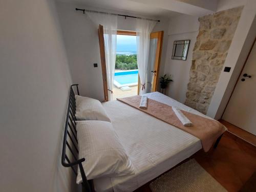 a bedroom with a bed with a view of the ocean at Olive Garden House in Šibenik