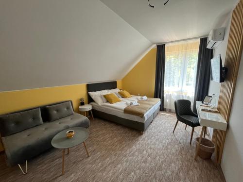 a living room with a bed and a couch at Aventurin House *** in Révfülöp