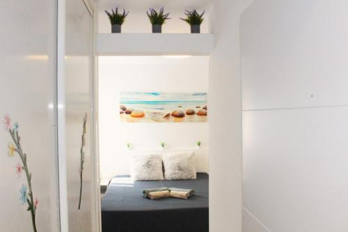 a room with a bed and plants on the wall at Panorama Benidorm Torre Montecarlo in Benidorm