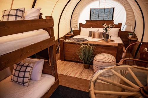 a bedroom with two bunk beds and a table at North Haven Campground in Bonners Ferry