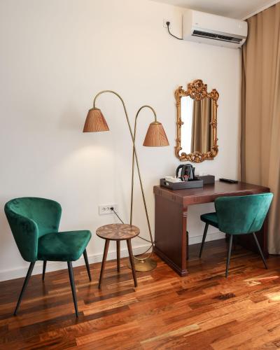 a desk and two chairs in a room with a mirror at Villa 1927 in Belgrade