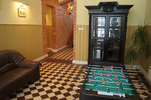 a room with a pool table and a couch at Pałac Spichrz in Borcz