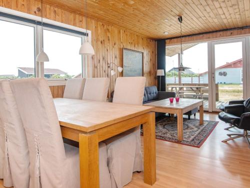 a dining room with a wooden table and chairs at 4 person holiday home in Harbo re in Harboør