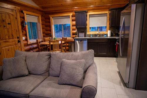 a living room with a couch and a kitchen at North Haven Campground in Bonners Ferry