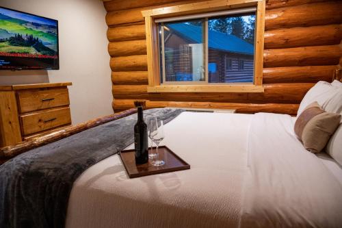 a bedroom with a bed with a bottle and glasses on it at North Haven Campground in Bonners Ferry