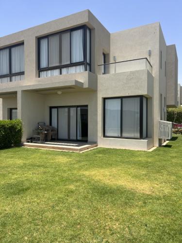 a house with a green lawn in front of it at Azha ain sokhna Luxury vacation villa - families only in Ain Sokhna