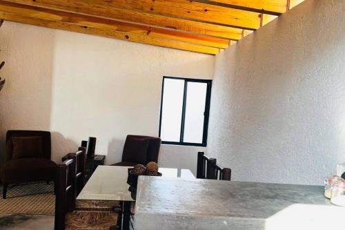 a room with a table and chairs and a window at Yaya’s Place 1 in Saltillo