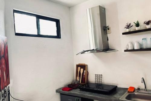 a kitchen with a sink and a window at Yaya’s Place 1 in Saltillo