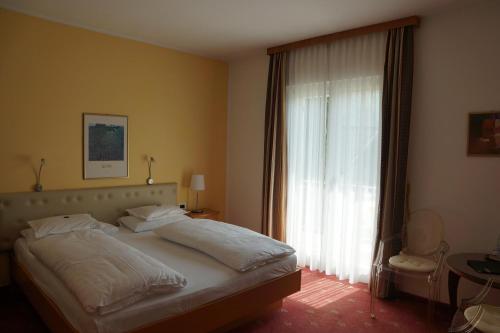 Postel nebo postele na pokoji v ubytování Hotel Zima