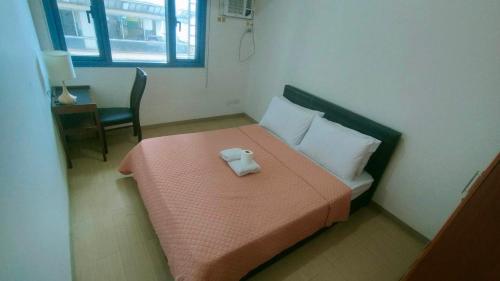 a small bedroom with a bed with a towel on it at Roxas Blvd Stunning Studio Condo Near US Embassy in Manila