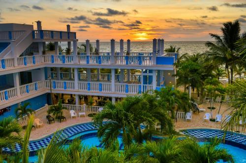 a view of the resort from the beach at sunset at Hotel Isla Mágica in Coveñas