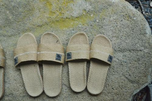 a pair of sandals sitting on a rock at 野窓 Nomadノマド Tsuwano GuestHouse & Cafe Lounge in Tsuwano