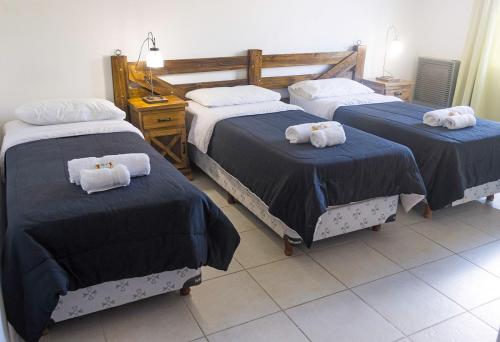 a bedroom with two beds with towels on them at Tranqueras Lodge in El Chalten