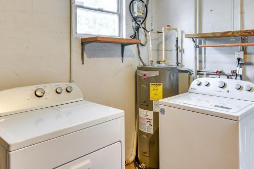 a laundry room with two machines and a window at Florida Escape with Pool, Near Beaches and Kayaking! in Daytona Beach