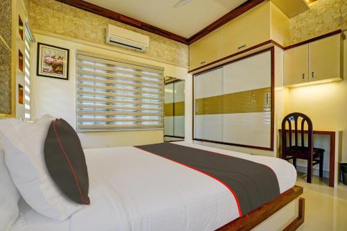 a bedroom with a large bed and a window at Collection O Lux villa in Nedumbassery