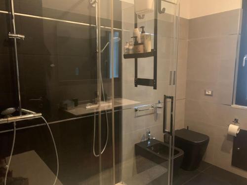 a bathroom with a glass shower and a toilet at Libertá 102 in Palermo