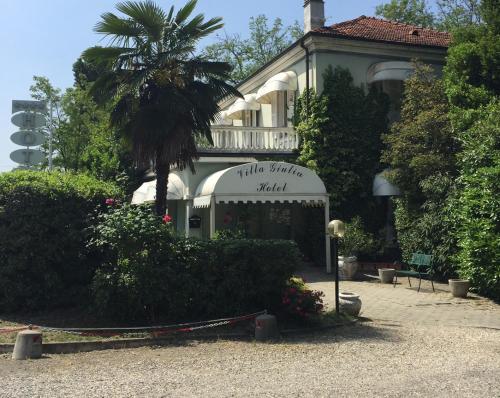 a building with a palm tree in front of it at Hotel Villa Giulia in Tortona