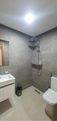 a bathroom with a shower and a toilet and a sink at Maison Lapierre d'agadir in Agadir