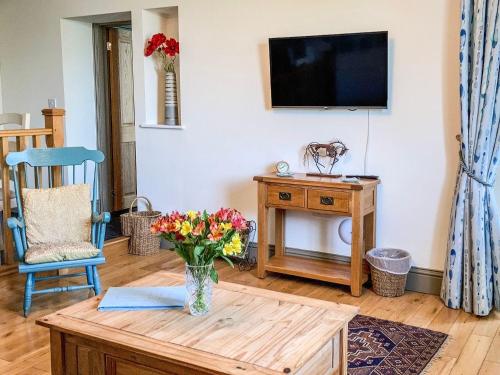 a living room with a vase of flowers on a table at North Walk House in Lynton