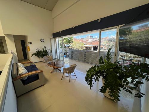 a living room with a couch and a large window at Hotel Boutique Santa Ana in Cartago