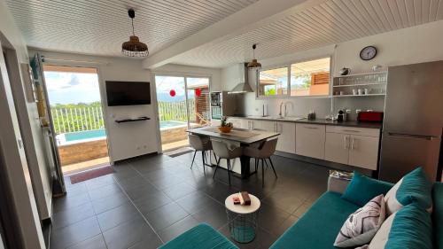 a kitchen and living room with a couch and a table at Kazadoli in Bois-Neuf
