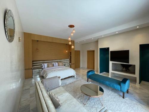 um quarto com uma cama e uma sala de estar com um sofá em Villa de luxe L'MNAM em Marrakech