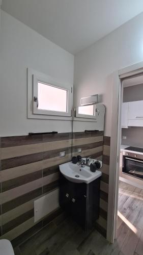 y baño con lavabo y espejo. en GORIZIA STYLE HOME, en SantʼAntìoco