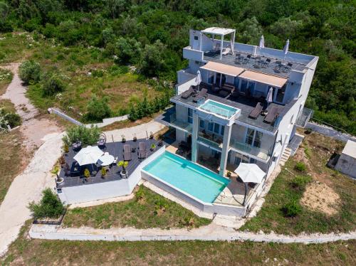 an aerial view of a house with a swimming pool at Villa Hacienda in Budva