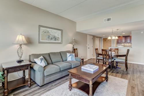 a living room with a couch and a table at Atlantic Ocean View Condo with Private Balcony and Access to Beachside Pool condo in Fernandina Beach