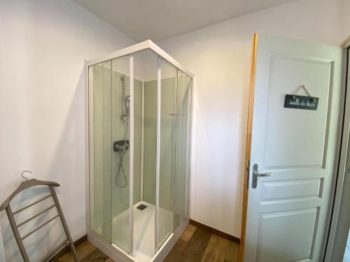 a shower with a glass door in a room at Semi-detached house, Lancheres in Lanchères