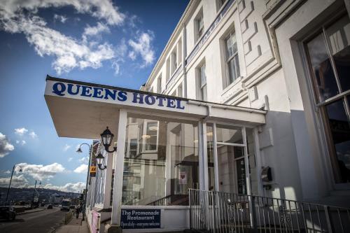 a queens hotel sign in front of a building at The Queens Hotel in Penzance