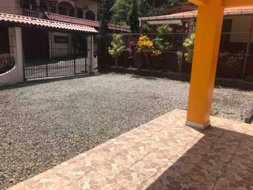 a yellow pole sitting in the middle of a driveway at Mahale - Quepos Manuel Antonio Reserve in Quepos
