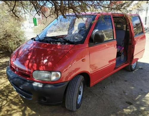 a small red van parked in a parking lot at w DiscoveryCanarias II in San Miguel de Abona