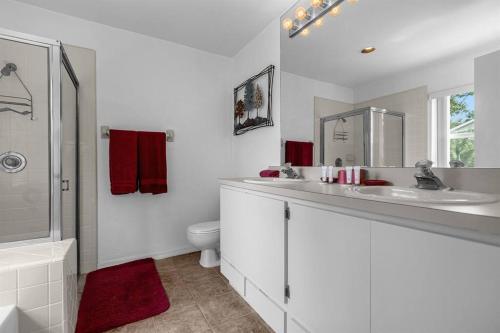 a white bathroom with a sink and a toilet at 2974 Viscount Villa 3bed+ Pool&Spa in Kissimmee