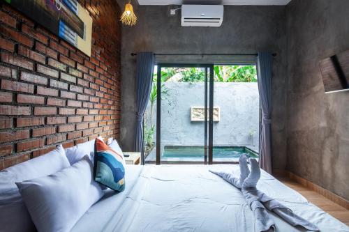 Ένα ή περισσότερα κρεβάτια σε δωμάτιο στο The Backyard Villas