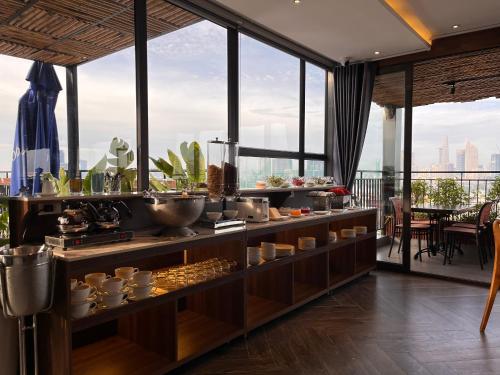 a buffet in a room with a view of the city at KunKin Garden Aparthotel in Ho Chi Minh City