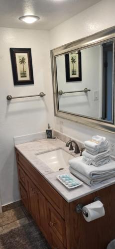 ein Bad mit einem Waschbecken und einem Spiegel in der Unterkunft Kihei Kai Nani Resort in Kihei