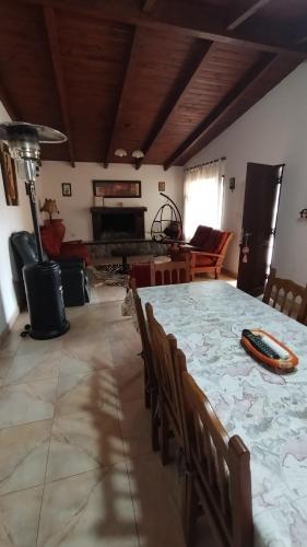um quarto com uma mesa e cadeiras e uma sala de estar em Casa tafi em Tafí del Valle