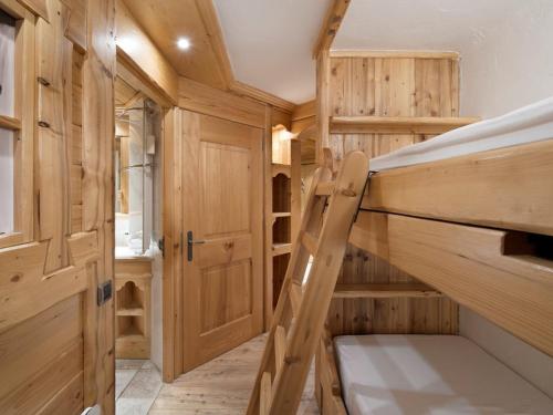 a small room with a bunk bed and wooden walls at Studio à Courchevel 1850, 4 pers, pieds des pistes, parking - FR-1-631-142 in Courchevel