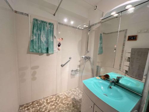 ein Badezimmer mit einem blauen Waschbecken und einer Dusche in der Unterkunft Appartement Saint-Aygulf, 2 pièces, 4 personnes - FR-1-226A-161 in Fréjus