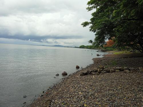 a body of water with rocks on the shore at Hostal La Cascada San Ramón in Mérida